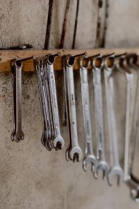Kaboompics - Vertical Close-Up of Silver Spanners on a Wooden Tool Rail