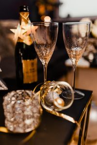 Kaboompics - Two Gold-Dotted Champagne Flutes and Festive Ornament with Bottle