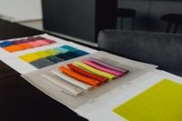 Kaboompics - Layered Upholstery Sample Boards and Color Swatches on a Designer's Worktable
