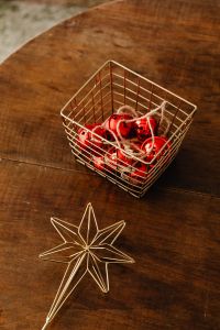 Kaboompics - Red Christmas Ornaments in a Wire Basket with Gold Star