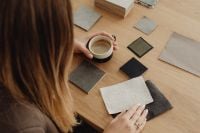 Kaboompics - Overhead View of Woman Reviewing Material Samples and Coffee