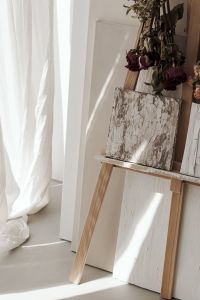 Kaboompics - Framed Artwork and Dried Flowers Beside White Curtains