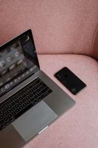 Kaboompics - MacBook Pro laptop & iPhone X mobile on a pink sofa
