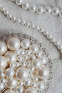 White Pearl Necklace Flat Lay Photography: Neutral Jewelry Backgrounds with Glass Dishes and Scallop Shell Styling