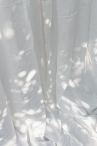 Kaboompics - Pooled White Curtains with Soft Shadow Patterns