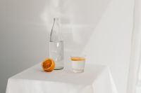 Kaboompics - Orange Juice in a Glass with Water Bottle and Fresh Citrus, Minimal Summer Drink Still Life