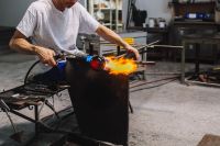 Kaboompics - Artisan Forming a Glowing Glass Orb Over a Furnace in Murano