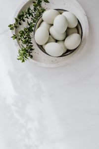 Kaboompics - Easter flat lay with green eggs on a white marble