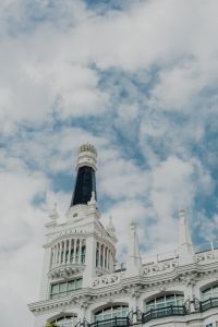 Kaboompics - Vertical Madrid Rooftop Tower with Dark Spire Against Cloudy Blue Sky