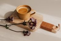Kaboompics - Coffee Cup with Astrantia on a Wooden Serving Board and Neutral Copy Space