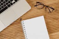 Kaboompics - Laptop, Glasses and Blank Notebook in a Wooden Desk Workspace, Overhead Flat Lay