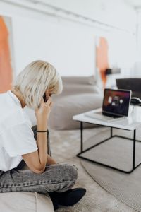 Kaboompics - Woman on Smartphone Call Beside Laptop in Home Office