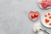 Kaboompics - Heart Chocolates, Macarons, and White Flower on Gray Surface