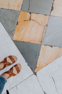 Kaboompics - Top-Down Leather Sandals on Gray and Ochre Marble Floor, Naples Italy Street Style Detail