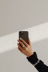Kaboompics - Hand Holding a Smartphone in a Sunlit Minimalist Interior