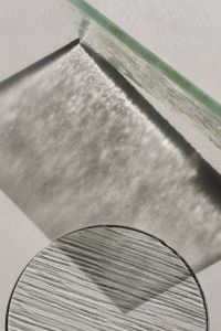Kaboompics - Layered Glass Panels and Ribbed Circular Surface with Cast Shadows