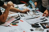 Kaboompics - Creative Team Sorting Photos and Printed Materials on Workspace