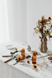 Kaboompics - Dried Flowers, Amber Bottles and Ceramic Vases for Neutral Table Decor