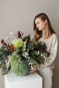 Kaboompics - Portrait of Woman With Festive Floral Arrangement