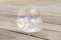 Kaboompics - Iridescent Bubble Cluster Resting on a Wooden Deck
