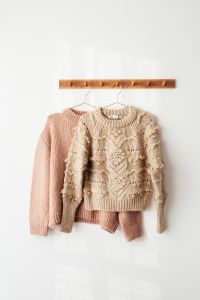 Kaboompics - Close-Up of Cream Cable-Knit Sweater on Hanger