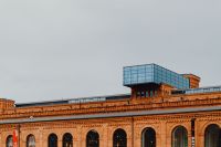 Kaboompics - Modern Glass Rooftop Addition above Historic Red-Brick Manufaktura in Łódź