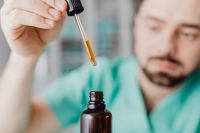 Kaboompics - Doctor Watching Liquid in Glass Dropper