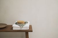 Kaboompics - Wooden Bench with Folded Towels and Body Brush