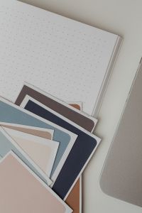 Kaboompics - Interior Design Color Palette on Dotted Notebook Beside Laptop