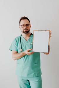 Kaboompics - Doctor Reviewing Notes on Medical Clipboard