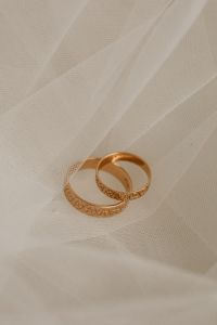 Kaboompics - Engraved Gold Wedding Rings Beneath Sheer Tulle