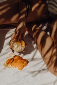 Kaboompics - Citrus Peel on a Sunlit Towel Beside Swimsuit-Clad Legs