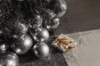 Kaboompics - Gold Wrapped Christmas Gift Beside Silver Balloons