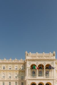 Kaboompics - Neoclassical Public Building with Italian and European Flags in Trieste