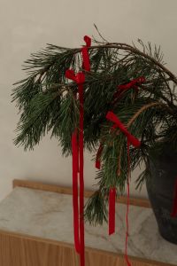 Kaboompics - Close Up Evergreen Branches with Red Velvet Ribbons on Marble Top Console