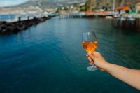 Kaboompics - Aperol Spritz overlooking Harbor Docks and Rocky Shore