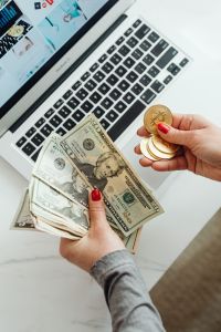 Kaboompics - Hand Holding US Dollar Bills and Bitcoin Coin