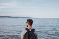 Kaboompics - Man with Backpack Facing the Blue Sea