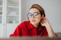 Kaboompics - Woman Pausing at Laptop with Hand behind Neck in Bright Home Office