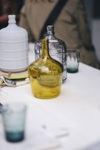 Kaboompics - Yellow Glass Bottle with Clear Vases and Drinking Glass