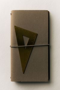 Kaboompics - Dark Notebook with Triangular Ruler Under Elastic Band