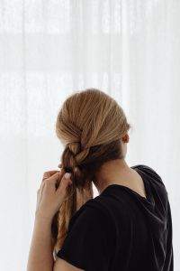 Kaboompics - Woman Braiding Her Hair from Behind