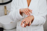 Kaboompics - A middle-aged woman applying hand cream