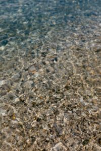 Kaboompics - Pale Blue Shallow Water Ripples across a Pebble Beach