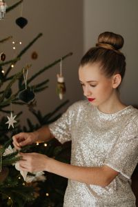 Kaboompics - Woman Decorating Christmas Tree at Home