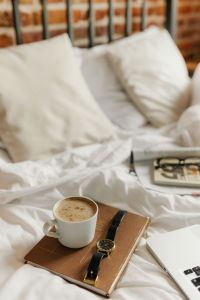 Kaboompics - Morning Coffee and Notebook on Unmade Bed, Cozy Lifestyle Background