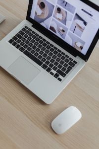 Kaboompics - Overhead Close-Up of Laptop Keyboard and White Mouse on a Light Wood Desk