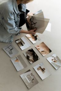 Kaboompics - Interior Designer Holding Architectural Images over a Creative Workspace