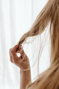 Kaboompics - Close-Up Hand Holding a Loose Hair Strand