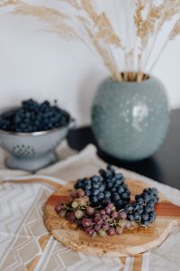 Kaboompics - Blueberries and Grapes on a Wooden Paddle Board